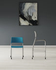 Two chairs, one blue and one silver, against a gray wall with an abstract painting. Kansas City Office Design