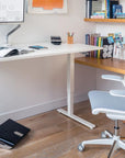 Home office setup with a adjustable desk, chair, and Humanscale FR500 black footrest. Kansas City Office Design.