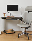 Modern office setup with a ergonomic chair, desk, and Humanscale FR300 footrest. Kansas City Office Design.