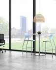 Modern office space with a table and chairs near large windows with a cityscape view. Kansas City Office Design