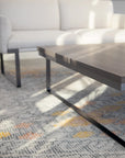 Wooden SitOnIt Cameo coffee table in a living room setting with a Cameo sofa and patterned rug. Kansas City Office Design