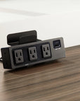 SitonIt Current Power strip with multiple outlets and USB ports on a wooden surface. Kansas City Office Design.