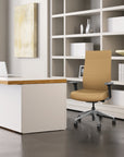 Modern office setup with a desk, highback Prava chair, and bookshelf. Kansas City Office Design