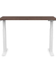 Front view of the SitonIt Switchback Height Adjustable Sit-to-Stand Desk. It has a White base with a 27"D x 54"W walnut top - Kansas City Office Furniture
