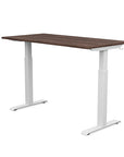 Back view of the SitonIt Switchback Height Adjustable Sit-to-Stand Desk. It has a White base with a 27"D x 54"W walnut top - Kansas City Office Furniture