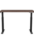 Front view of the SitonIt Switchback Height Adjustable Sit-to-Stand Desk. It has a Black base with a 27"D x 54"W walnut top - Kansas City Office Furniture