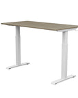 Back view of the SitonIt Switchback Height Adjustable Sit-to-Stand Desk. It has a White base with a 27"D x 54"W Sandalwood top - Kansas City Office Furniture
