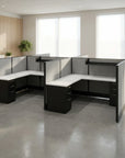 Modern office desk setup with partitioned workstations in a bright room. Kansas City Office Design