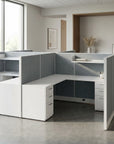 Modern office setup with L-shaped desk and gray partition walls. Kansas City Office Design