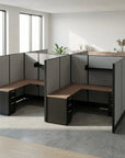 Modern office cubicle setup with wooden desks and gray partitions in a bright room. Kansas City Office Design