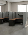Modern office cubicle setup with gray walls and wooden desks in a bright room. Kansas City Office Design