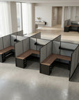 Modern office cubicles with gray partitions and wooden desks in a bright room. Kansas City Office Design