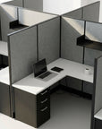 Modern office cubicle with a laptop, phone, and mug on a white desk. Kansas City Office Design
