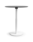 Humanscale Float Gather 36" round Table in white base with black laminate top in standing position. Kansas City Office Design.