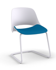 Side view of a Humanscale Trea Chair with cantilever guest chair base and glides. In white finish with a peacock fabric padded seat. Kansas City Office Furniture.