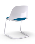 Back view of a Humanscale Trea Chair with cantilever guest chair base and glides. In white finish with a peacock fabric padded seat. Kansas City Office Furniture.
