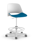 Side view of a Humanscale Trea Chair with stool base and casters. In white finish with a peacock fabric padded seat. Kansas City Office Furniture.