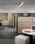 Modern office space with wooden cubicles and a desk with a laptop. Kansas City Office Design