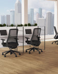 Modern office setup with black chairs and desk in front of a cityscape view. Kansas City Office Design
