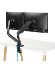 Back view of the SitOnIt Mobi Dual Monitor Arm in Black mounted to the Reya Home Desk. Kansas City Office Design