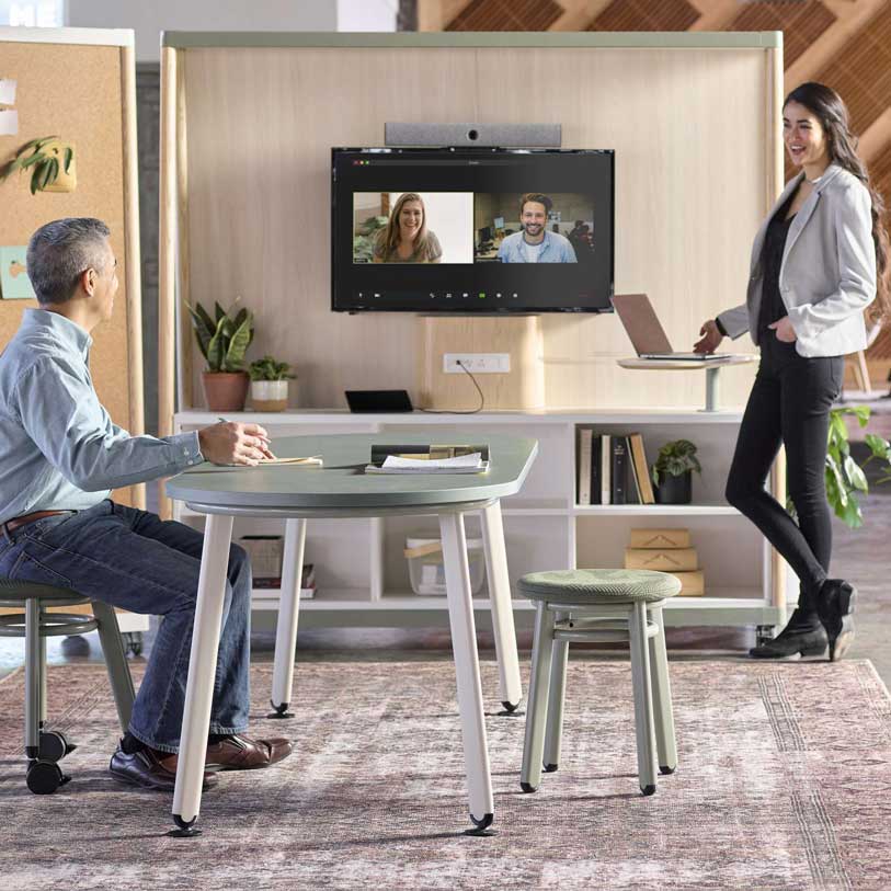 Two people meeting with video conferencing around a table making furniture selections. OFS furniture. Kansas City Office Furniture.
