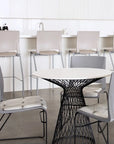 Modern dining area with a round table and chairs in a minimalistic setting. Kansas City Office Design.