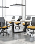 Modern office conference room with a large table and gray chairs with yellow seats. Kansas City Office Design