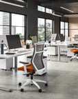 Modern office space with desks, chairs, and large windows. Kansas City Office Design