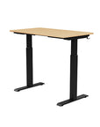 Back view of the SitonIt Switchback Height Adjustable Sit-to-Stand Desk. It has a Black base with a 24"D x 42"W Maple top - Kansas City Office Furniture