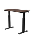 Back view of the SitonIt Switchback Height Adjustable Sit-to-Stand Desk. It has a Black base with a 24"D x 42"W Walnut top - Kansas City Office Furniture