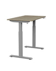 Side view of the SitonIt Switchback Height Adjustable Sit-to-Stand Desk. It has a Silver base with a 24"D x 42"W Sandalwood top - Kansas City Office Furniture