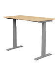 Back view of the SitonIt Switchback Height Adjustable Sit-to-Stand Desk. It has a Silver base with a 24"D x 48"W Maple top - Kansas City Office Furniture