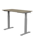 Back view of the SitonIt Switchback Height Adjustable Sit-to-Stand Desk. It has a Silver base with a 24"D x 48"W Sandalwood top - Kansas City Office Furniture
