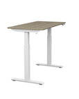 Side view of the SitonIt Switchback Height Adjustable Sit-to-Stand Desk. It has a White base with a 24"D x 48"W Sandalwood top - Kansas City Office Furniture