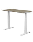 Back view of the SitonIt Switchback Height Adjustable Sit-to-Stand Desk. It has a White base with a 24"D x 48"W Sandalwood top - Kansas City Office Furniture