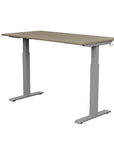 Back view of the SitonIt Switchback Height Adjustable Sit-to-Stand Desk. It has a Silver base with a 27"D x 54"W Sandalwood top - Kansas City Office Furniture