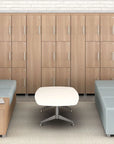 Modern office waiting area with wooden lockers, gray couches, and a white lounge coffee table.
