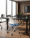Modern office meeting room with tables, chairs, and a large screen TV. Kansas City Office Design.