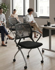Modern office setting with people sitting on chairs and a desk. Kansas City Office Design.