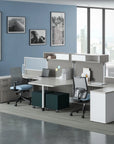 Modern office setup with desks, chairs, and wall art in a bright room. Kansas City Office Design