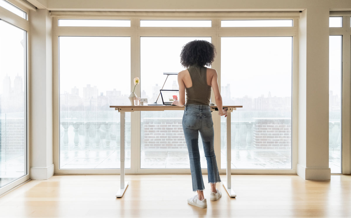Humanscale eFloat Go 2.0 Sit-Stand Desk with bamboo top and white base in the standing position – Kansas City Office Design