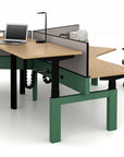 Modern office power bench sit to stand desk setup in 120 degrees with green legs, wooden surface, and office chair on a white background. Kansas City Office Design.