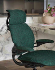 Green Humanscale Freedom office chair in a kitchen setting with a marble countertop and kitchen appliances. Kansas City Office Design.