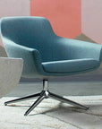 Modern blue Gobi lounge chair with a star-shaped base on a textured floor. Kansas City Office Design.
