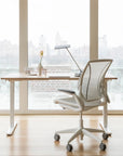 Humanscale World Chair with white mesh, white frame at a height adjustable desk overlooking city — back view – Kansas City Office Design