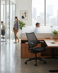Modern office space with desks, chairs, and large windows. Kansas City Office Design.