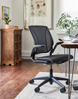 Modern office chair in a home office setting with a desk and FR500 Humanscale footrest. Kansas City Office Design.