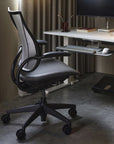 Ergonomic Humanscale Liberty office chair in front of a desk with computer setup. Kansas City Office Design.