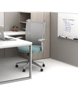 Modern office setup with a desk, chair, and whiteboard in a neutral color scheme. Kansas City Office Design