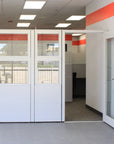 Modern office space with glass partitions and red accents. Kansas City Office Design